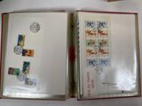 an open book with stamps on it sitting on a table