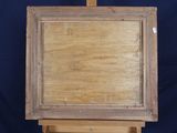 an old wooden easel with a painting on it against a blue background