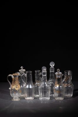 an image of a group of glass vases sitting on top of a table