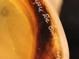a close up of a glass with a liquid inside of it