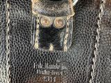 a close up of a leather case with a metal handle