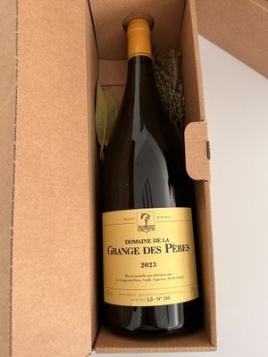a bottle of wine in a box on a table