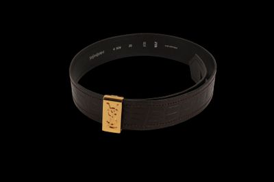 a close up of a black belt with a gold buckle