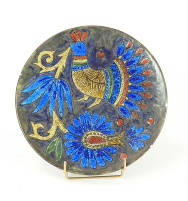 a blue plate with a bird on it on a stand