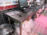 an image of a kitchen with a computer on a table