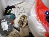 a pile of clothes and shoes in a plastic bag