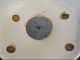a dirty toilet bowl with a hole in it