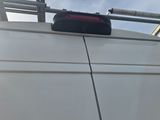 a white van with a suitcase on top of it