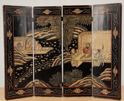 a black and gold room divider with a painting on it