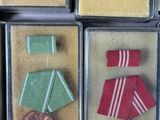 four different medals are in a box on a table