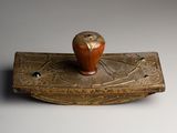 an image of a small wooden object with a bird on it