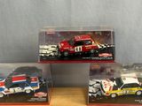 three toy cars in a display case on a table