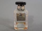 a small bottle of perfume on a table