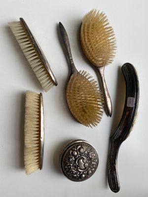 a lot of brushes and combs on the table