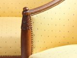 a yellow chair with a wooden frame and a yellow chair with blue dots on it