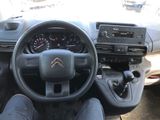 the interior of a car with a steering wheel and dashboard controls