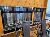 a row of metal chairs in front of a row of ice cream machines