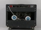 a black amp with two speakers in it on a white surface