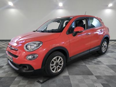 the red fiat suv is parked in a large room