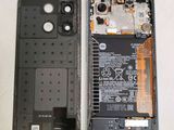 the back of a cell phone with a battery attached to it
