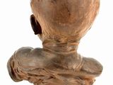 sculpture of a bust of a child on a wooden base
