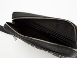 the inside of a black and white purse on a white surface