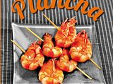 a plate of shrimp skewered on skewers on a table