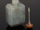 an image of a white jade box with a wooden stick in front of it