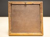 a close up of a wooden frame on a table with a black background