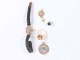 an assortment of jewelry including a watch, bracelet, ring, and earring