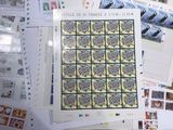 a lot of stamps on a table with a picture of a penguin