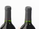 six bottles of wine are lined up in a row on a table