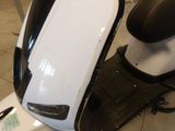 a scooter that is sitting on the floor in the room