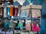 many bags of different colors and sizes on the shelves
