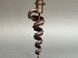 an old metal candle holder with a spiral design on it