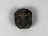 an image of a small metal object on a white surface