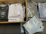 a lot of t - shirts in a box on a table