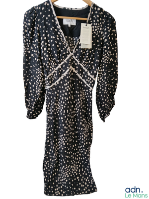 an image of a black and white polka dot dress on a hanger