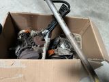 a cardboard box with tools in it sitting on the floor