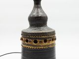 a black and gold vase with a black top