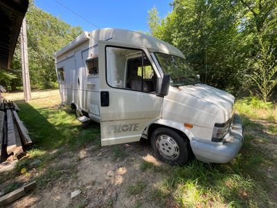 un camion blanc garé dans l'herbe