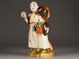 chinese figurine of a monk holding a book and a bag