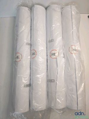 four rolls of toilet paper wrapped in plastic on top of a table