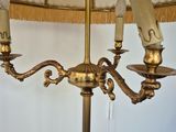 a lamp that is sitting on a table with a lamp shade on it