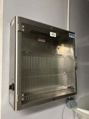 a stainless steel cabinet with a bucket on the side of it