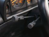 a close up of a car dashboard with a steering control