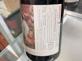 a bottle of wine that is being held by a person
