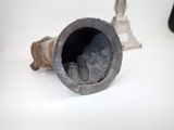 a small metal object on a white surface next to a small metal object
