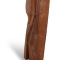 a wooden sculpture that is on display on a white surface