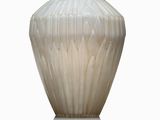 a white vase sitting on a table with a white background